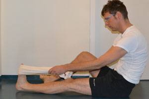 using a towel to aid your hamstring stretch